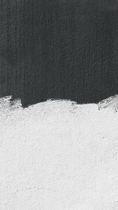 a black and white wall with some paint on it