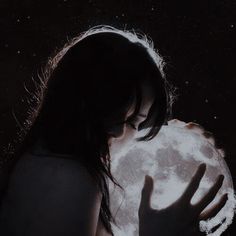 a woman holding the moon in her hands