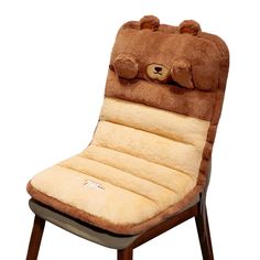 a chair that has a teddy bear pillow on it's back and is shaped like a sleeping bag