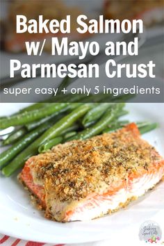 baked salmon with parmesan mayo crust on a white plate next to green beans