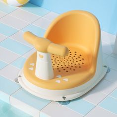 a yellow and white baby bath tub with a spigot on it's side