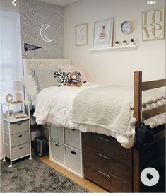 a bedroom with a bed, dressers and pictures on the wall