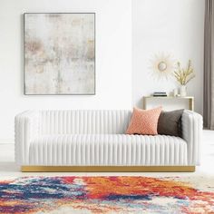 a living room with a white couch and colorful rug