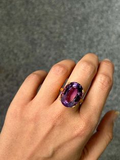 For Sale on 1stDibs - Make a statement with this stunning 17.95 carat purple Amethyst solitaire cocktail ring. The center stone is completely clean, with no inclusions at all, Luxury Purple Oval Gemstones, Luxury Purple Sapphire Ring, Oval Amethyst Ring In Luxury Style, Timeless Oval Purple Amethyst Ring, Luxury Solitaire Amethyst Ring, Timeless Purple Oval Amethyst Ring, Luxury Purple Amethyst Ring, Luxury Purple Sapphire Ring For Formal Occasions, Luxury Polished Amethyst Ring