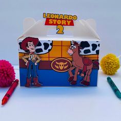 a toy box with a cartoon character on it next to some pom poms