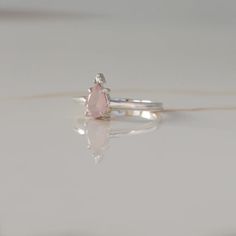 A ring that reminds you of the queen that you are? A pear-shaped Rose Quartz topped with a round Moissanite is giving us full-on royal vibes and we are loving it. A little treat-yourself gift never hurt nobody! Details: Center stone Gemstone: Rose Quartz Stone Shape: Pear Measurements: approx. 7x5mm Side stones Gemston Teardrop Diamond Ring For Proposal, Delicate Teardrop Ring For Gifts, Teardrop Solitaire Ring For Proposal, Teardrop Rose Cut Diamond Promise Ring, White Gold Teardrop Diamond Ring Gift, Teardrop Gemstone Ring For Proposal, Pear-shaped Birthstone Promise Ring, Pear-shaped Rose Cut Diamond Rings For Proposal, Pear Shaped Rose Cut Diamond Ring For Proposal