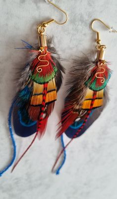 This unique long Bohemian earrings is perfect gift for her. This  hand made feather earrings they are modern elegant and made just a little bit different.  If u are on the hunt for the perfect handmade jewelry that will hold its meaning for years to come you landed  in right place. Perfect for weddings / bridesmaids gifts / parties, birthday gifts, fancy dress.    This customizable earrings makes the perfect gift for mom.   This listing is for 1 pair of your choosing :  -navy  -  yellow Making Feather Earrings, Native Feather Earrings, Bohemian Gold Earrings With Peacock Design, Multicolor Feather Jewelry For Festivals, Bohemian Peacock Earrings For Gift, Bohemian Peacock Earrings As Gift, Peacock Bohemian Earrings For Gift, Peacock Bohemian Earrings As Gift, Peacock-colored Bohemian Earrings For Gift