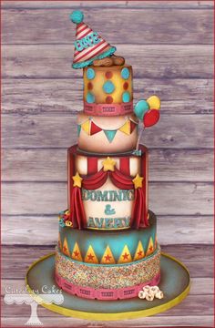 a multi layer cake decorated with clowns and balloons