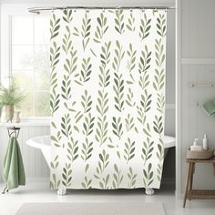 a shower curtain with green leaves on it