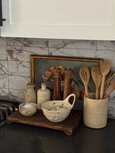 kitchen utensils are sitting on a counter top