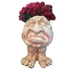 a ceramic planter with red carnations in it's head