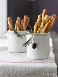 two white containers filled with french fries on top of a table