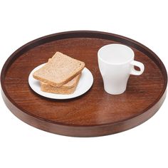 two pieces of bread on a plate next to a cup