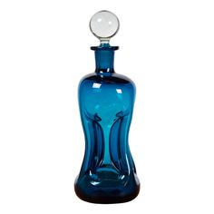 a blue glass bottle with a ball in it's top on a white background