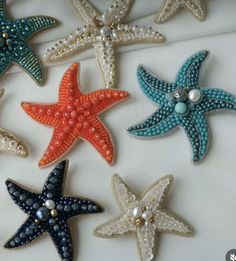 six starfish appliques with pearls and beads on them are arranged in rows