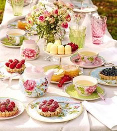 a table topped with plates and cups filled with desserts