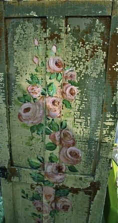 an old door with flowers painted on it