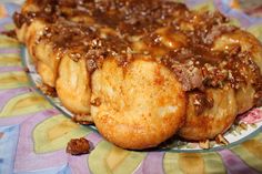 a close up of a plate of food on a table cloth with other items in the background