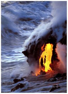 a man standing on top of a lava covered beach next to the ocean with waves crashing over him