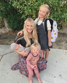 a woman and two children posing for a photo