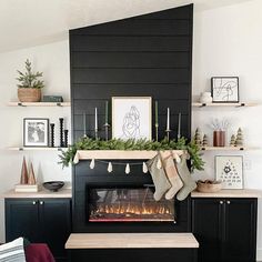 a living room with a fireplace and christmas stockings hanging on the mantel above it