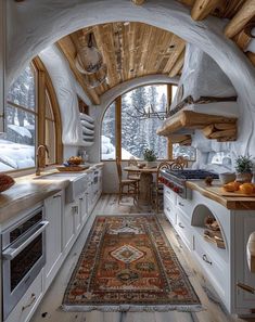 an interior view of a kitchen and dining area in a snow - capped mountain cabin