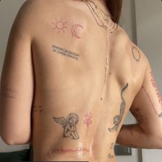 the back of a woman with tattoos on her body