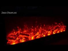 a fire place that is lit up in the dark with red flames and black background