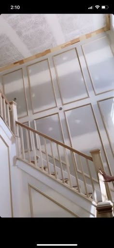 a stair case in the middle of a room with glass panels on the walls and ceiling