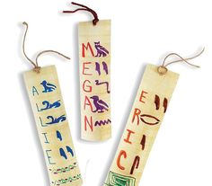 three wooden bookmarks with writing on them