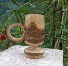 a wooden mug sitting on top of a table