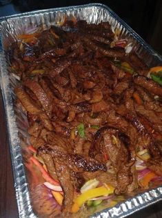 meat and vegetables are being cooked in foil