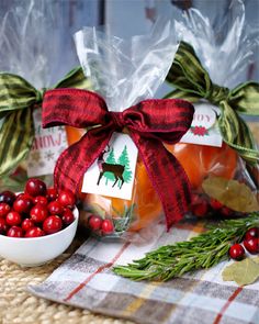 two bags filled with oranges and cranberries on top of a table