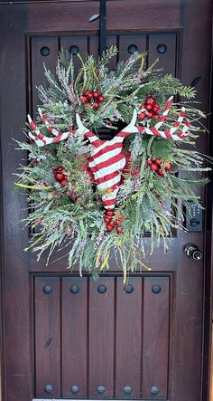 a christmas wreath hanging on the front door