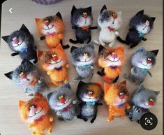 a bunch of stuffed cats sitting on top of a table