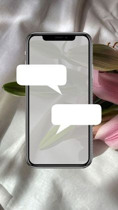 an iphone with two conversation bubbles on the screen next to pink tulips and white sheets