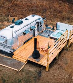 an rv parked on top of a wooden platform