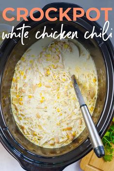 crockpot white chicken chili in a crock pot with a spatula on the side