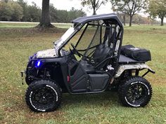 a small utility vehicle parked in the grass