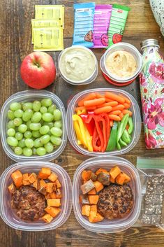 the meal is prepared and ready to be eaten on the table with fruit, veggies, crackers, and dip