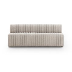 a white couch sitting on top of a white floor