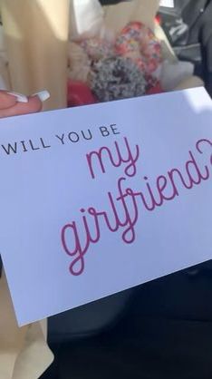 a sign that says will you be my girlfriend?