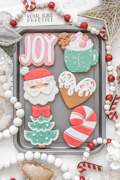 decorated christmas cookies are displayed on a tray