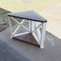 a white and brown table sitting on top of a sidewalk