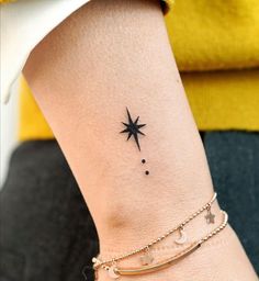 a small star and moon tattoo on the left side of the ankle, with two stars above it