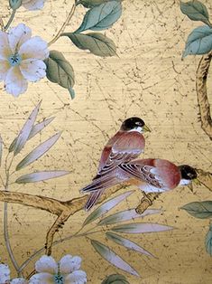 two birds sitting on a branch with white flowers