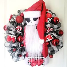 a wreath with a skeleton wearing a santa hat