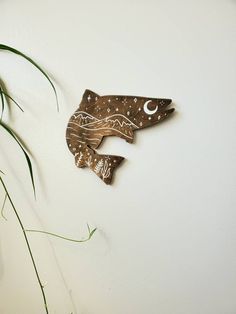 two wooden fish are hanging on the wall