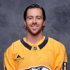 a man in a hockey jersey posing for a photo