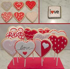 some heart shaped cookies are on sticks and in the shape of lollipops